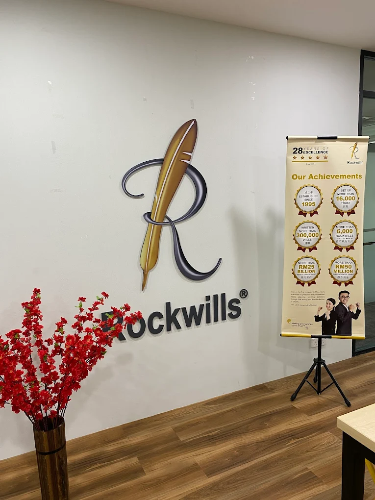 Rockwills Kuantan reception wall with logo and achievements display, highlighting trusted will executor executorship Kuantan services.